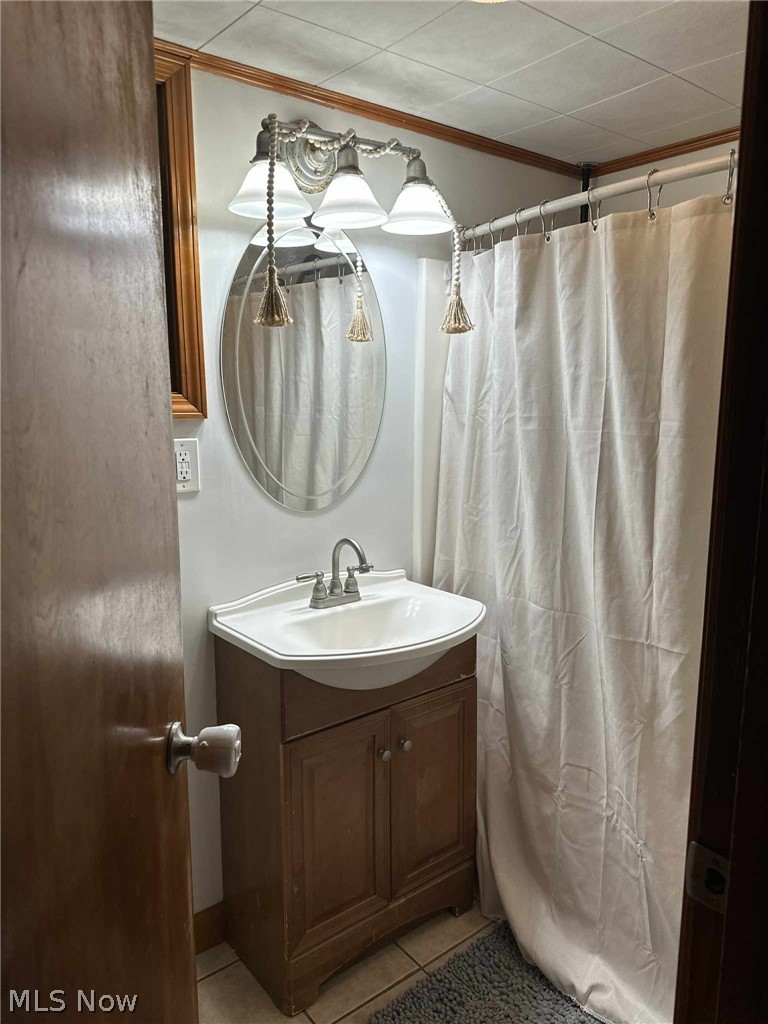 595 Jersey Ridge Road Zanesville, OH 43701 - Photo 9 of 20 Bathroom with vanity, curtained shower, light tile patterned floors, and crown molding