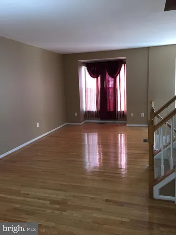 a view of room with window and wooden floor