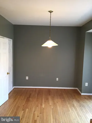 an empty room with windows and entrance