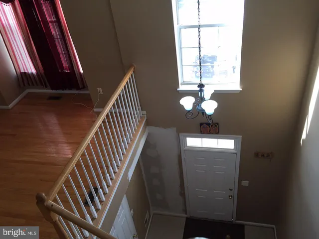 an empty room with windows and fireplace