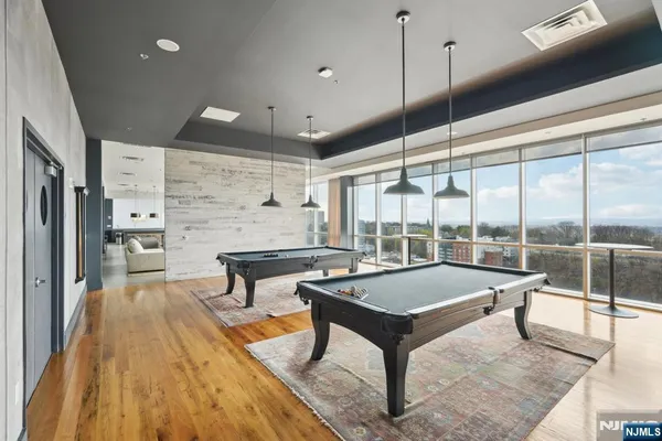 a living room with a table chairs and a large window