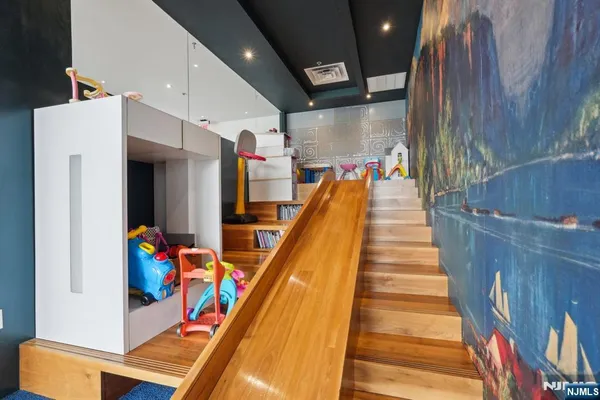 a view of a living room with wooden floor and a large window