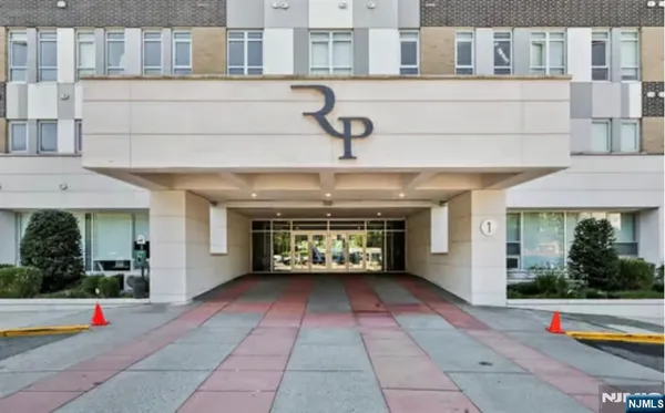 a front view of a building with outdoor seating