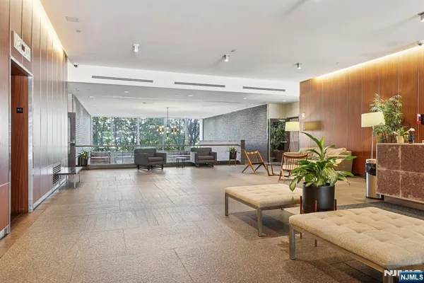 a lobby with furniture and a potted plant