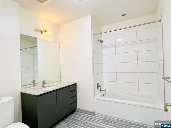 a bathroom with a double vanity sink and a bathtub