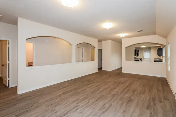 a view of a hallway with wooden floor