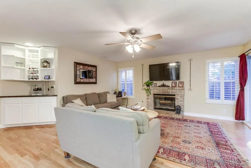 13919 Poway Valley Road Poway, CA 92064 - Photo 22 of 70 a living room with furniture a fireplace and a flat screen tv