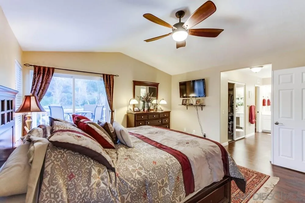 13919 Poway Valley Road Poway, CA 92064 - Photo 36 of 70 a bed room with a bed and a ceiling fan