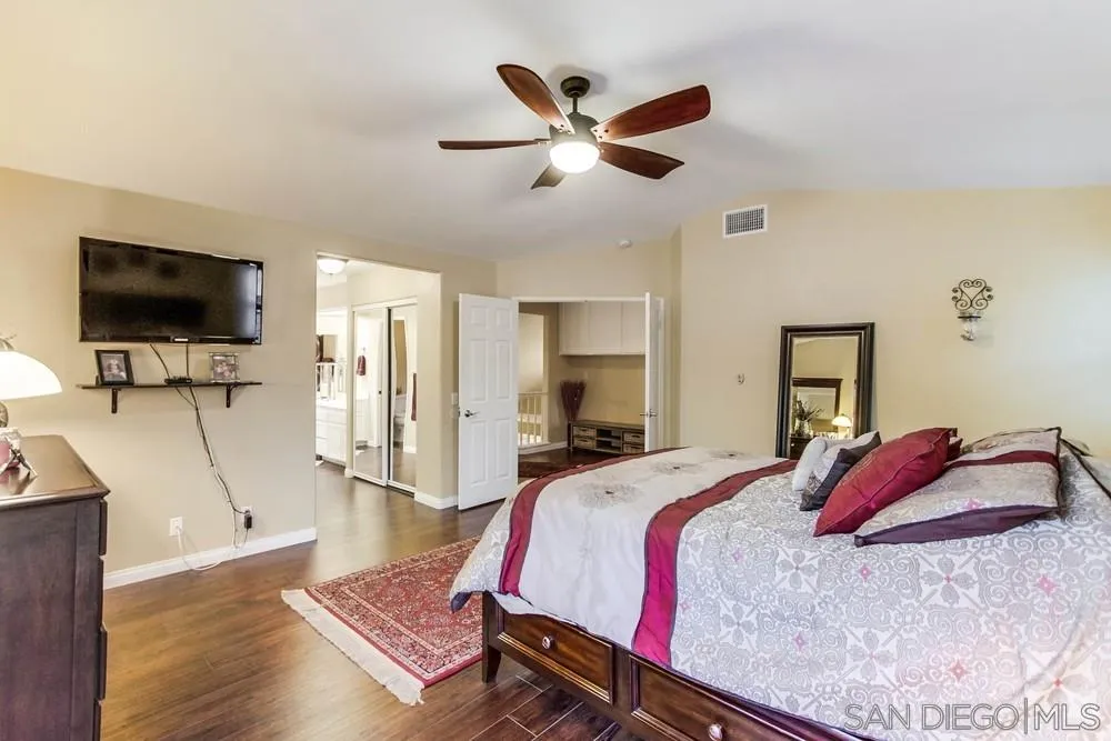 13919 Poway Valley Road Poway, CA 92064 - Photo 37 of 70 a spacious bedroom with a bed and a flat screen tv