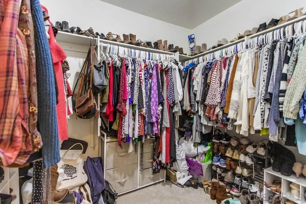 13919 Poway Valley Road Poway, CA 92064 - Photo 41 of 70 a view of walk in closet with clothes
