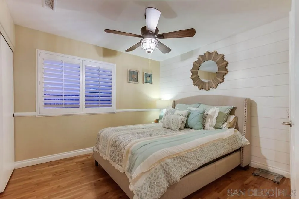 13919 Poway Valley Road Poway, CA 92064 - Photo 48 of 70 a bedroom with a large bed and a chandelier