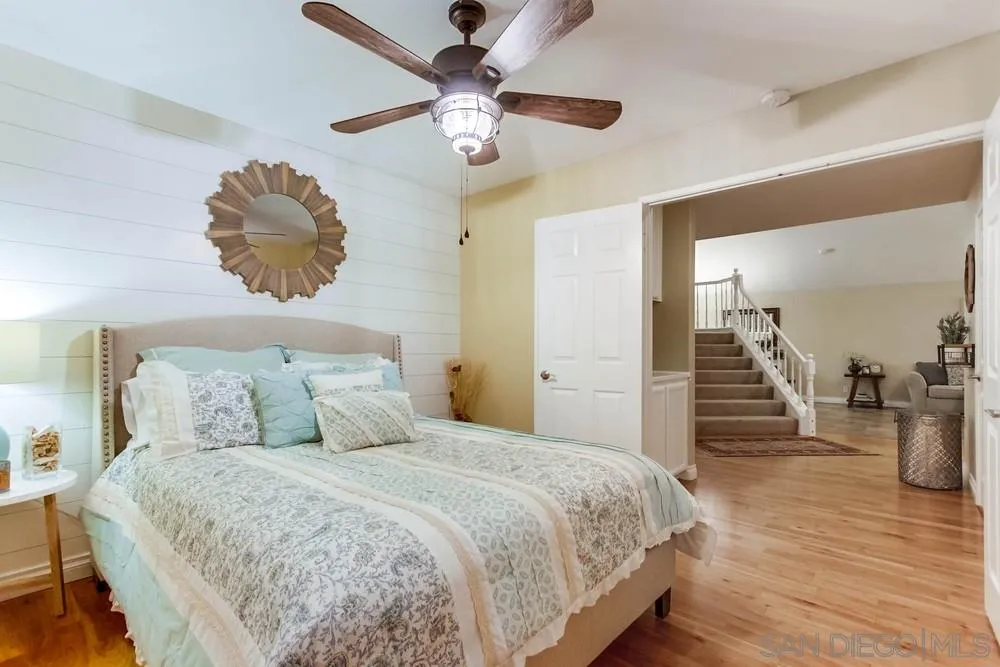 13919 Poway Valley Road Poway, CA 92064 - Photo 50 of 70 a bedroom with a bed and a chandelier