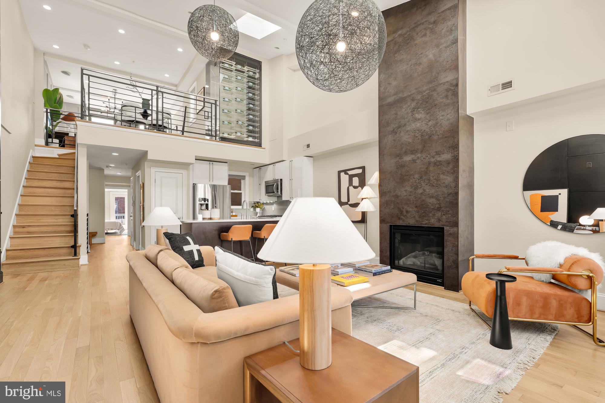 a living room with furniture a fireplace and kitchen view
