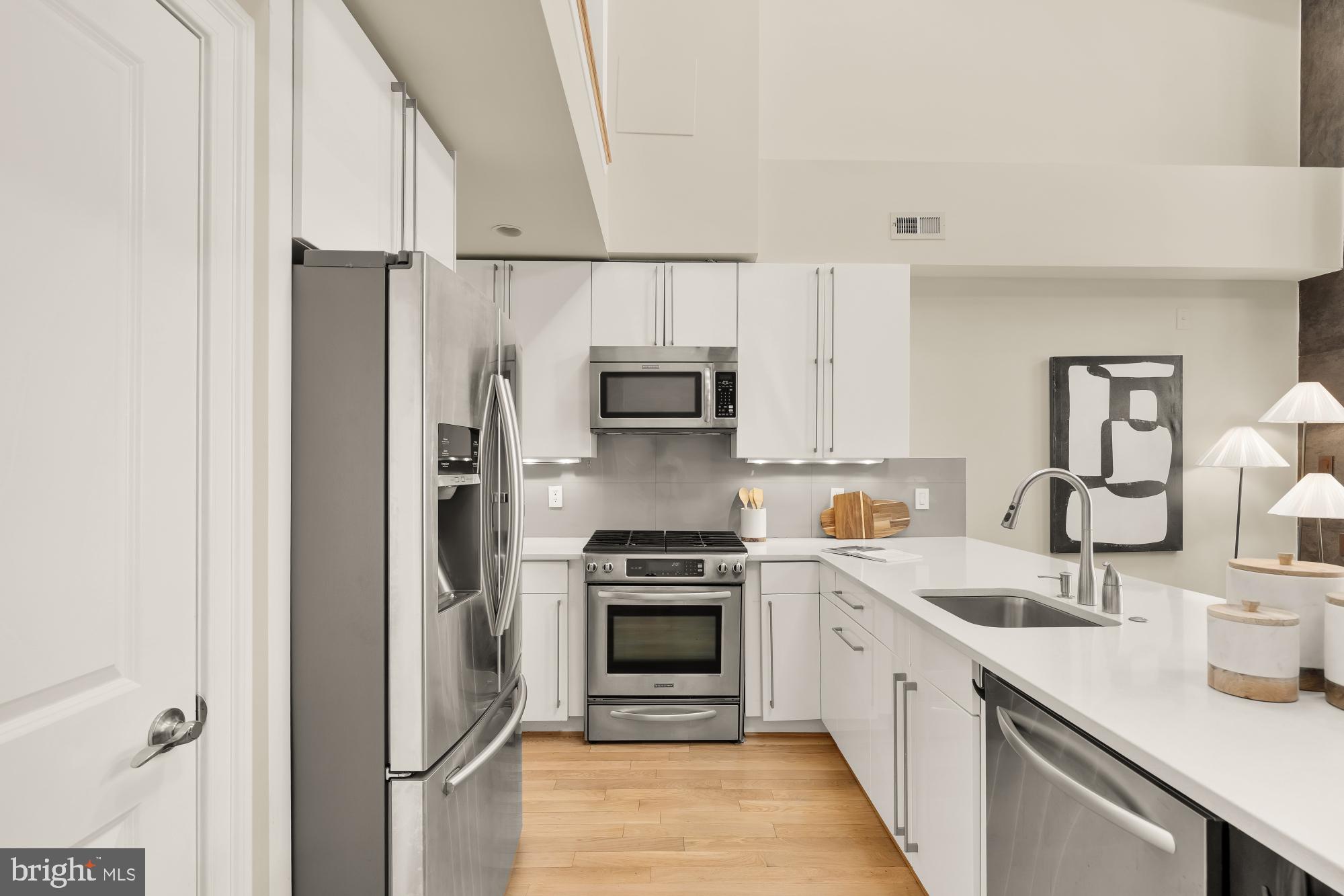 2431 Ontario Road Northwest, Unit 4 Washington, DC 20009 - Photo 15 of 48 a kitchen with stainless steel appliances granite countertop a refrigerator sink and stove