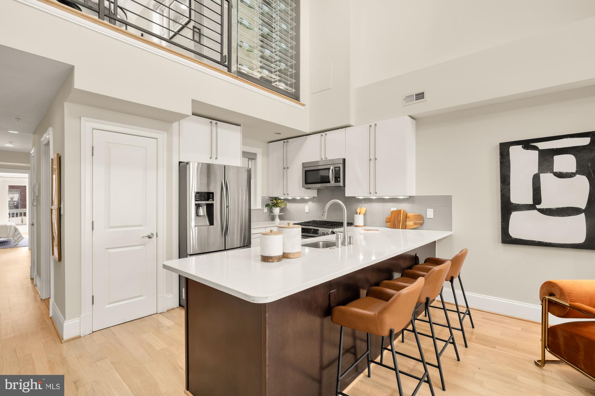 2431 Ontario Road Northwest, Unit 4 Washington, DC 20009 - Photo 16 of 48 a kitchen with stainless steel appliances a refrigerator and a stove top oven