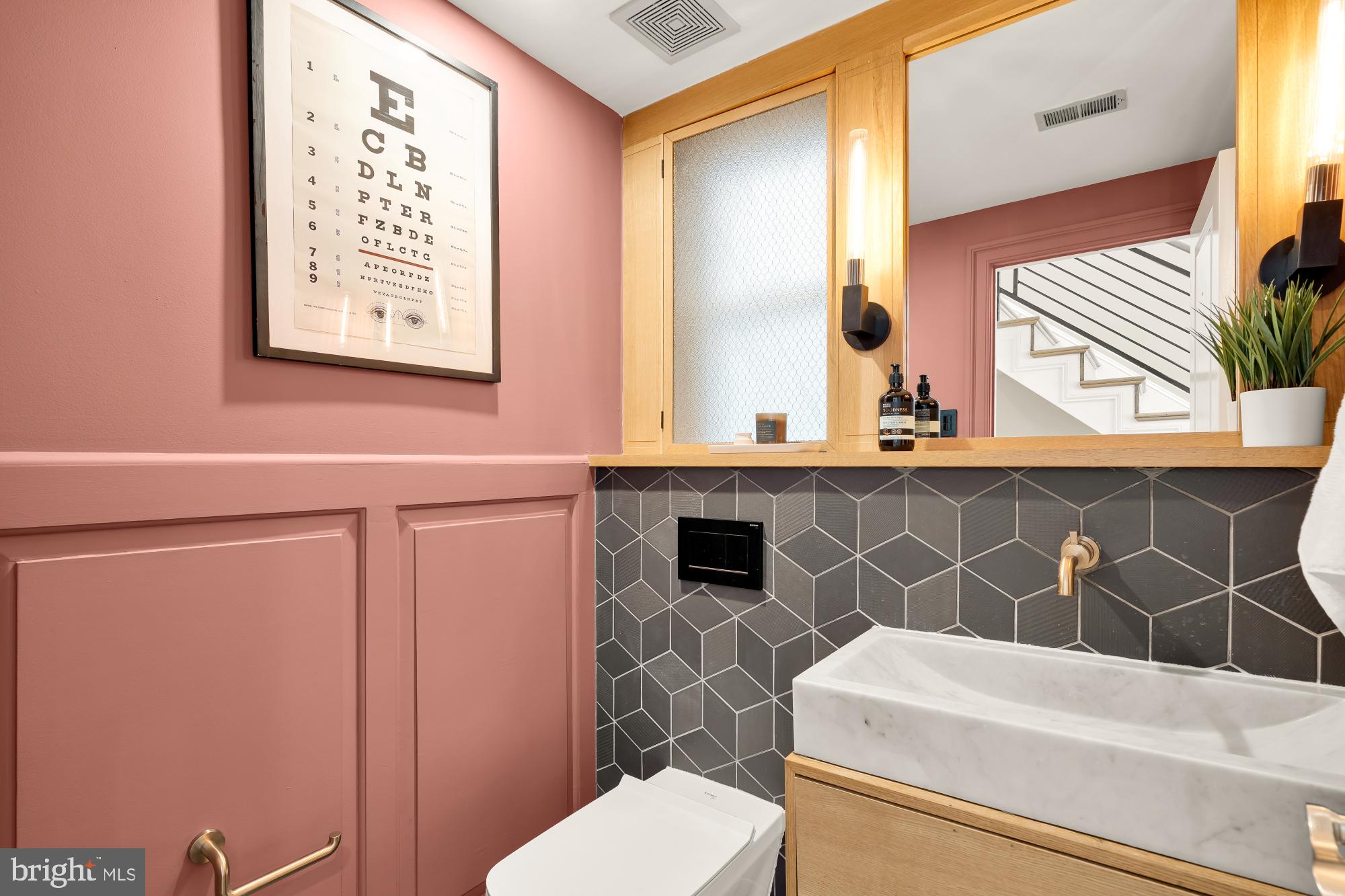 2431 Ontario Road Northwest, Unit 4 Washington, DC 20009 - Photo 18 of 48 a bathroom with a sink a toilet and mirror