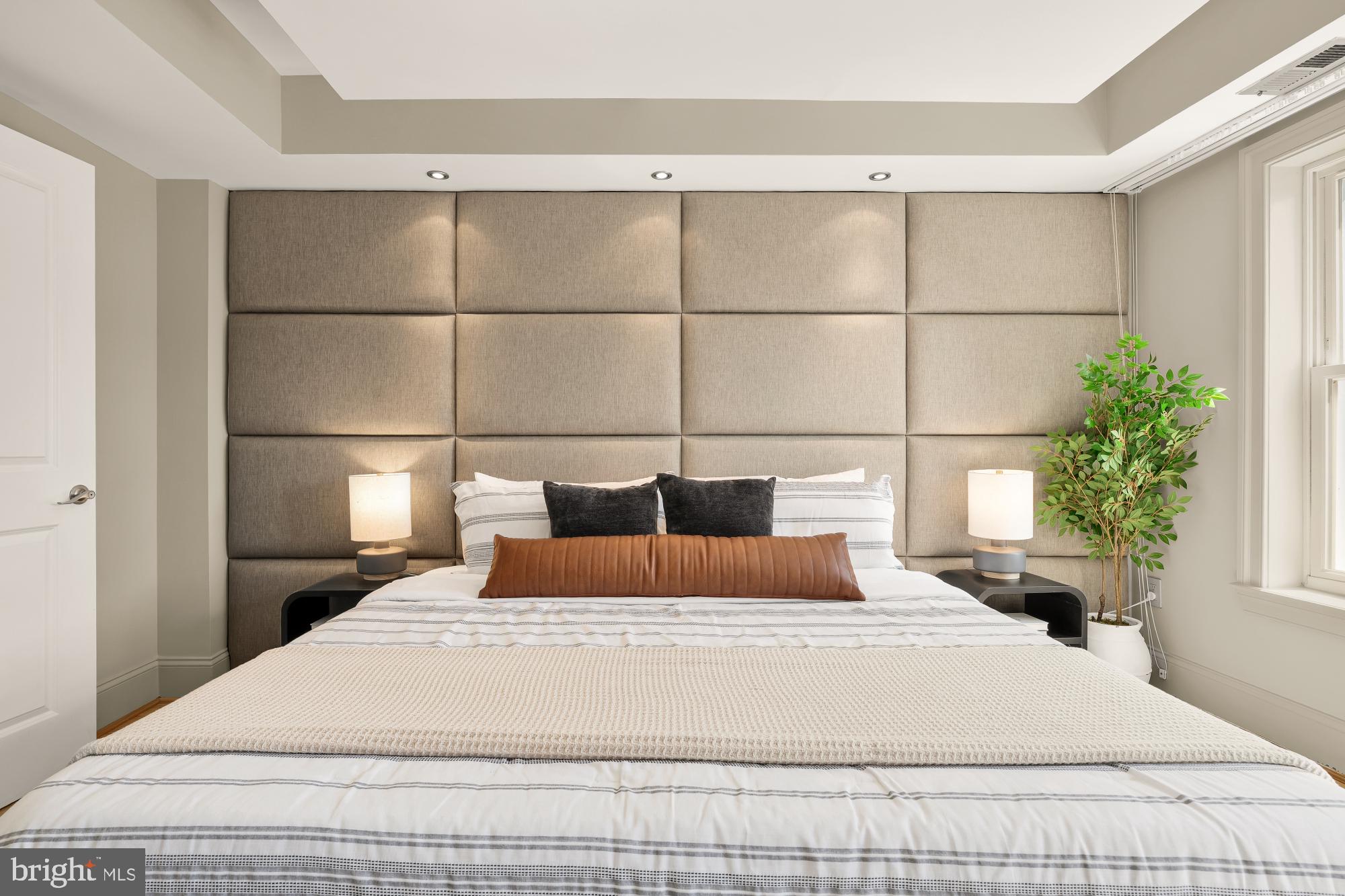 2431 Ontario Road Northwest, Unit 4 Washington, DC 20009 - Photo 21 of 48 a bedroom with a bed and a potted plant