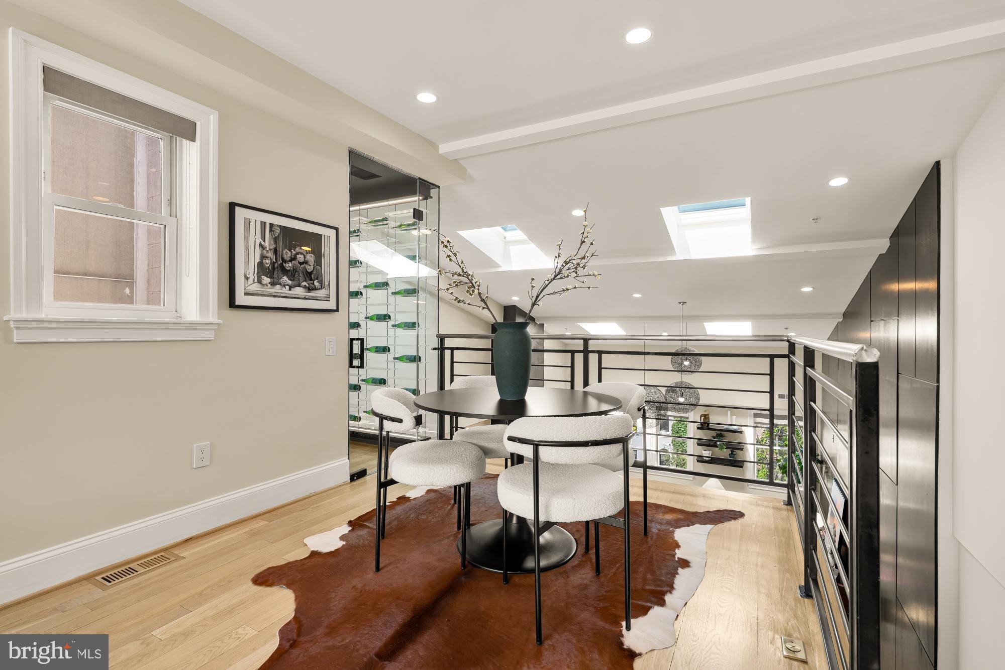 2431 Ontario Road Northwest, Unit 4 Washington, DC 20009 - Photo 31 of 48 a room with lots of wooden furniture and a chandelier