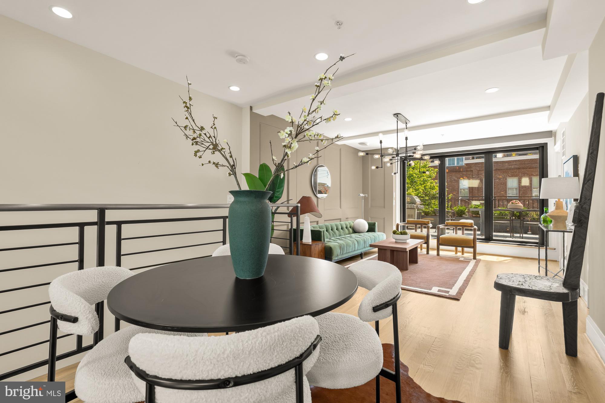 2431 Ontario Road Northwest, Unit 4 Washington, DC 20009 - Photo 39 of 48 a dining room with furniture a chandelier and wooden floor