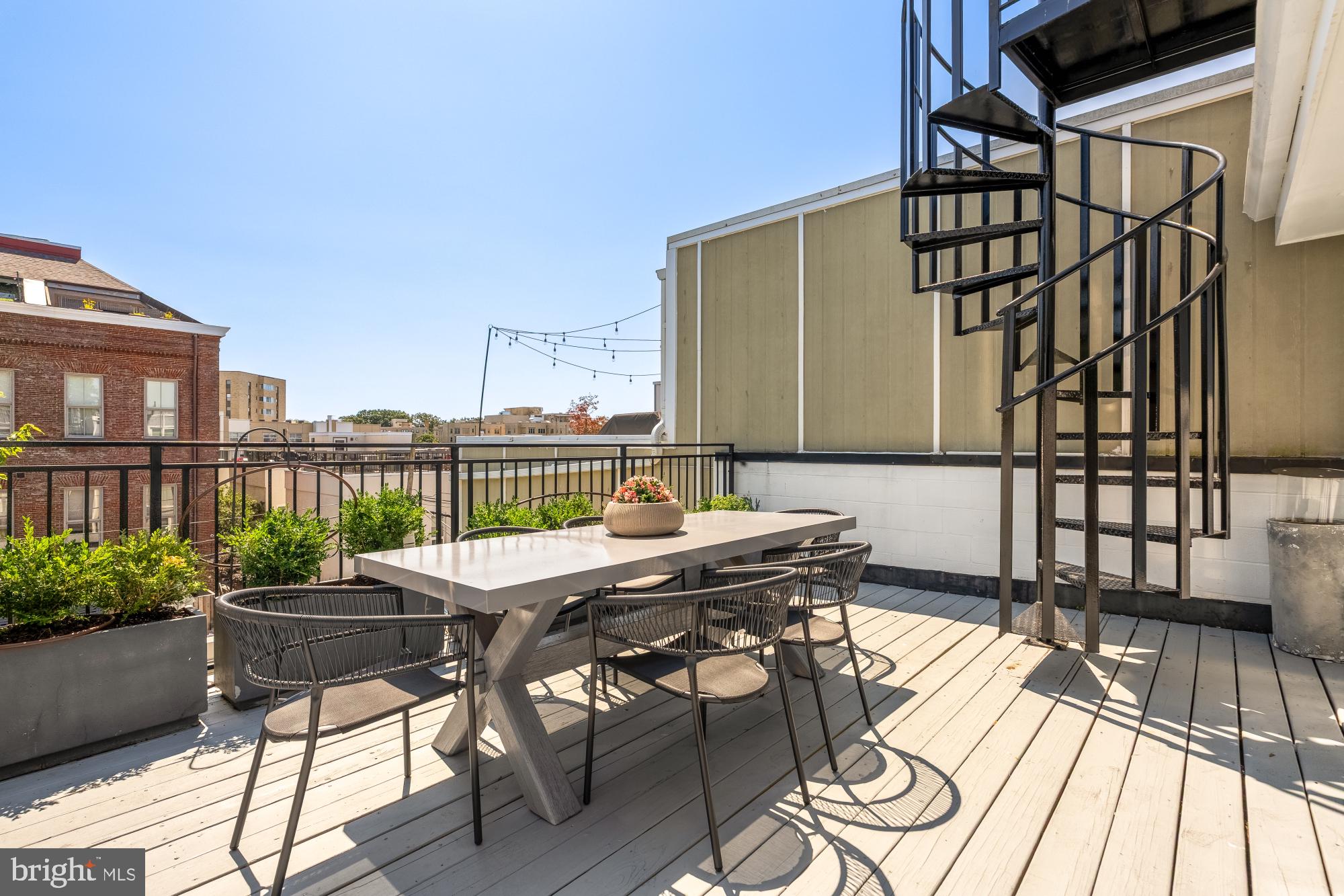 2431 Ontario Road Northwest, Unit 4 Washington, DC 20009 - Photo 43 of 48 a patio with table and chairs and potted plants