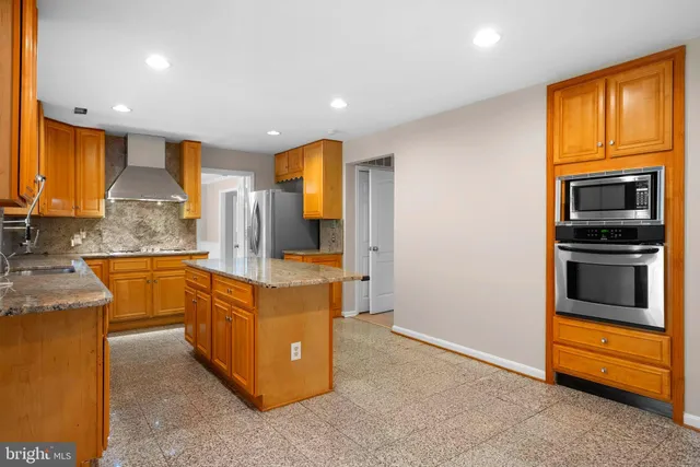 a kitchen with stainless steel appliances granite countertop a stove and a refrigerator