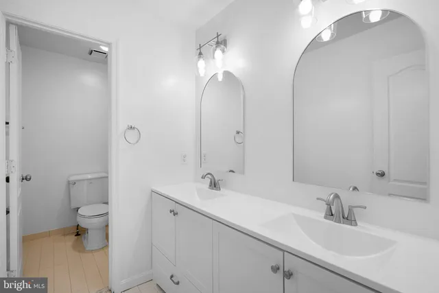 a bathroom with a tub sink and mirror