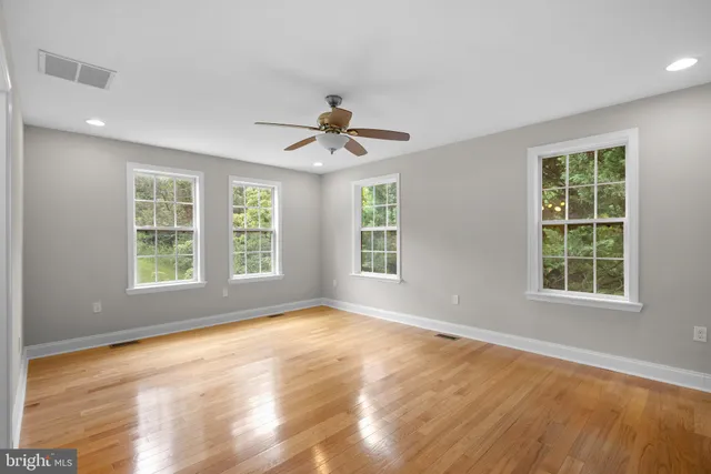 a bathroom with a sink toilet vanity and shower