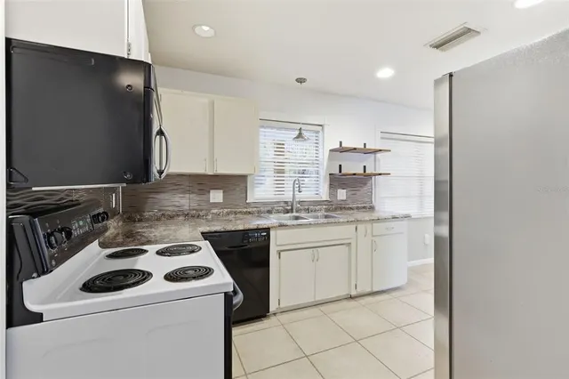 a kitchen with a stove and a refrigerator