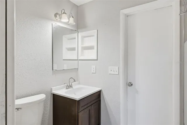 a bathroom with a sink toilet and vanity