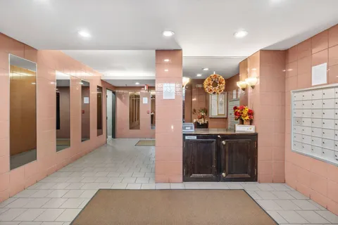 a view of hallway with chandelier and entryway