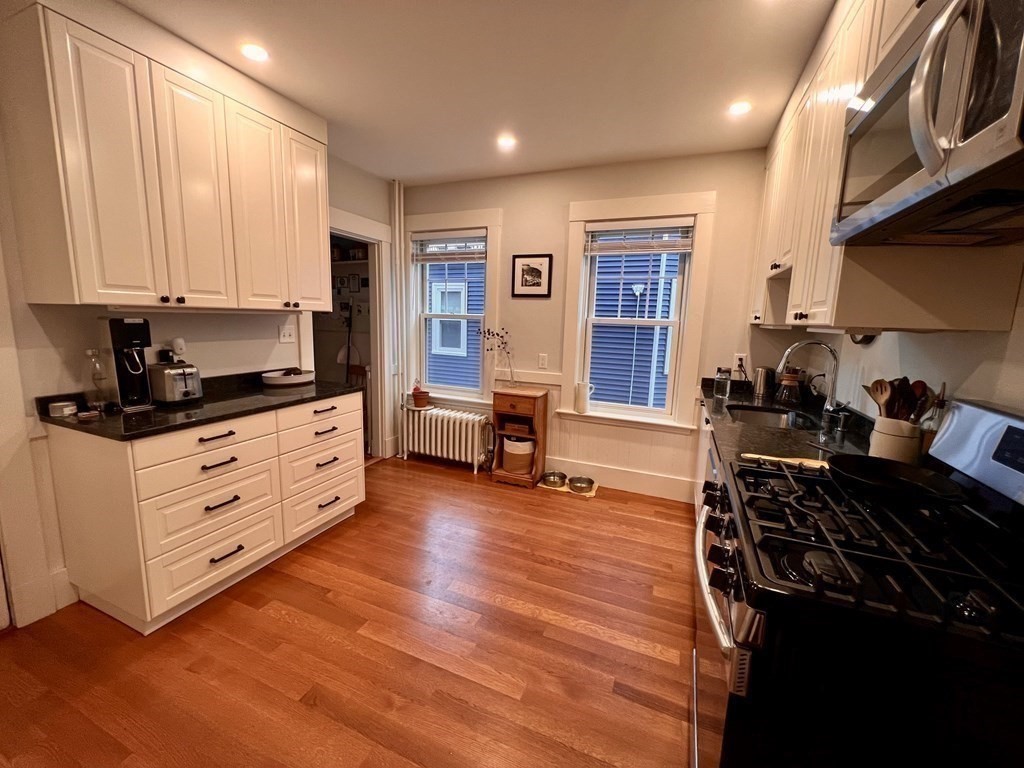 12 Rosemary Street, Unit 1 Boston, MA 02130 - Photo 12 of 17 a kitchen with stainless steel appliances a stove a sink and a refrigerator
