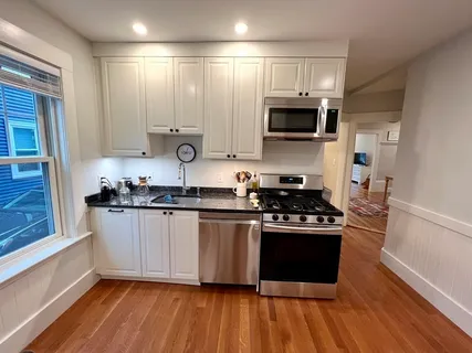 a kitchen with stainless steel appliances granite countertop a stove and a sink