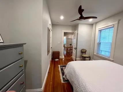a bed room with a bed and a mirror