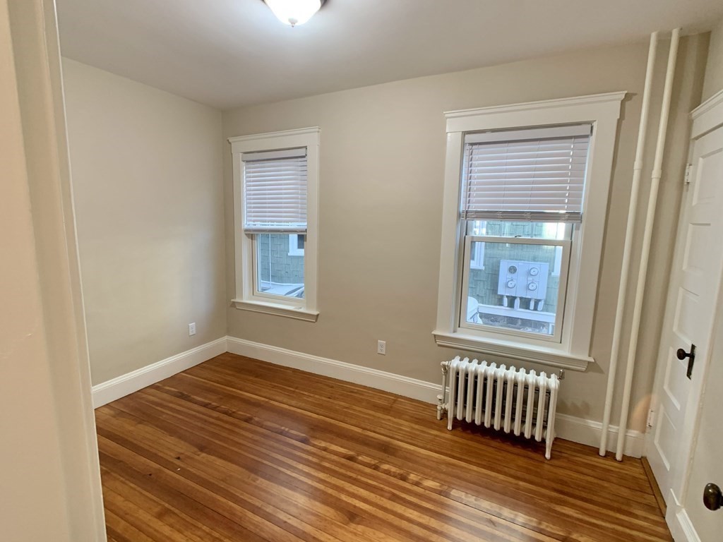 12 Rosemary Street, Unit 1 Boston, MA 02130 - Photo 10 of 17 a view of empty room with wooden floor and fan