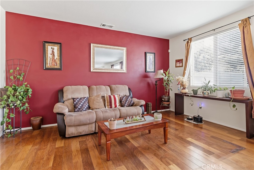152 Alabaster Loop Perris, CA 92570 - Photo 18 of 29 a living room with furniture and flowers