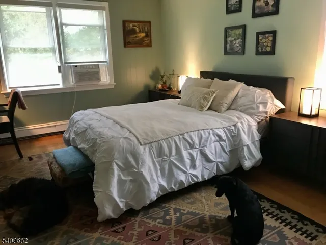 a bedroom with a bed and window