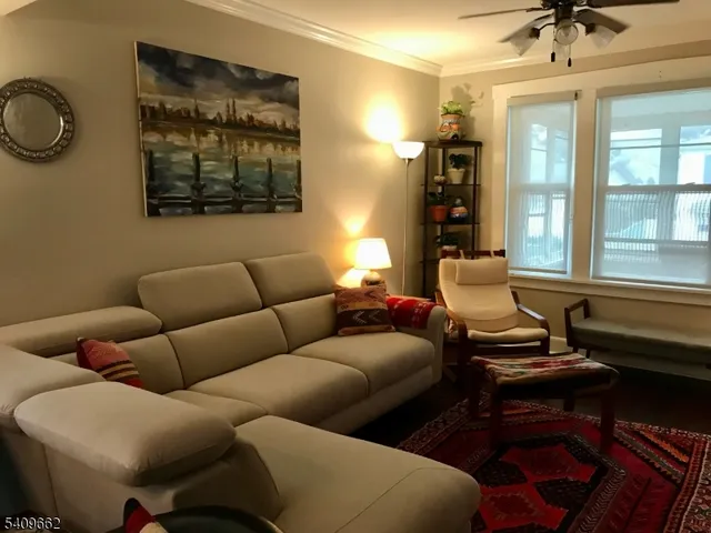a living room with furniture a rug and a window