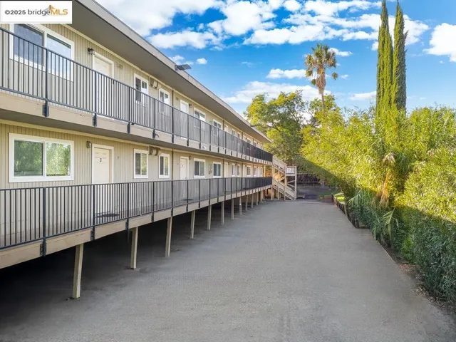a view of a house with a yard and pathway
