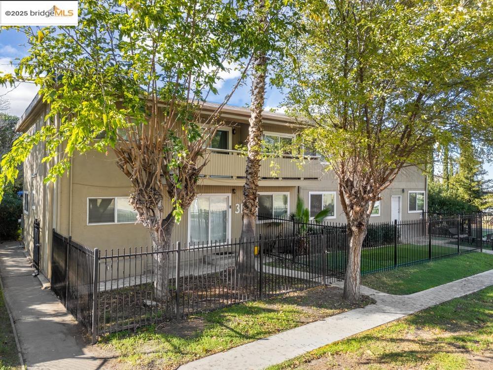3126 Lone Tree Way Antioch, CA 94509 - Photo 7 of 24 View of front facade featuring a fenced front yard, a balcony, and stucco siding
