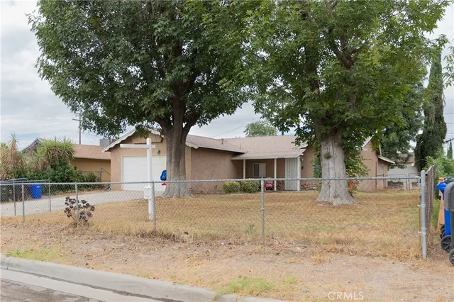a front view of a house with a tree