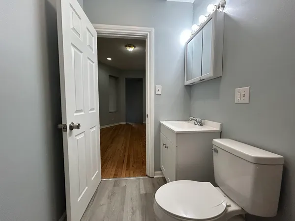 a white toilet sitting next to a bathroom sink