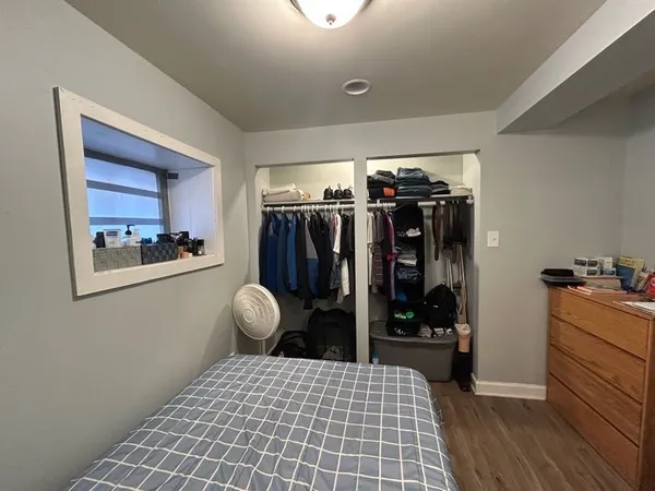 a bedroom with a bed and a walk in closet
