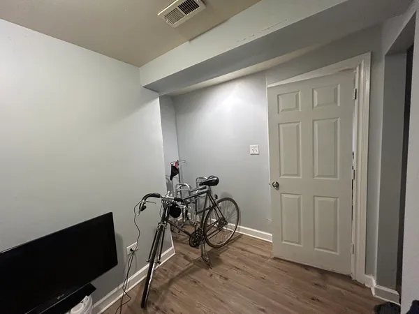 a view of a room with wooden floor