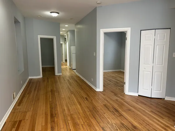 a view of hallway with wooden floor