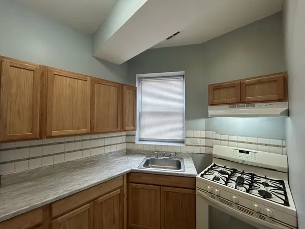 a kitchen with a sink stove and cabinets
