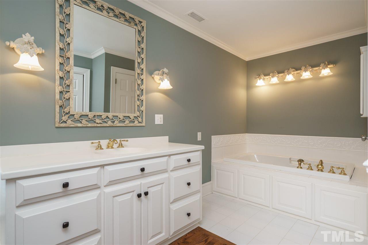 8446 Seven Paths Road Spring Hope, NC 27882 - Photo 11 of 24 a bathroom with a sink and a mirror