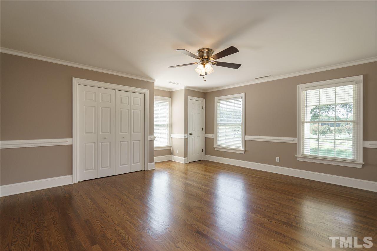 8446 Seven Paths Road Spring Hope, NC 27882 - Photo 13 of 24 a view of an empty room with wooden floor and a window