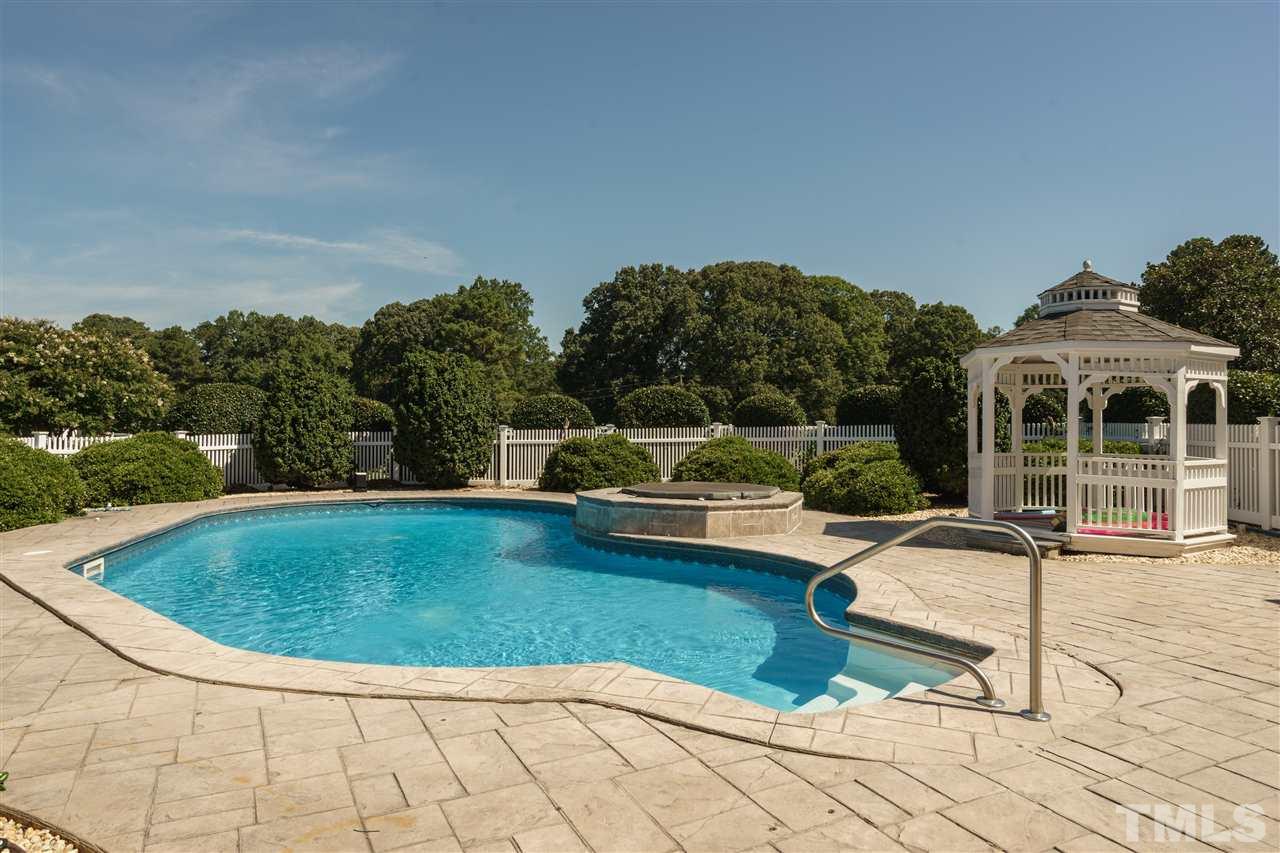 8446 Seven Paths Road Spring Hope, NC 27882 - Photo 14 of 24 a view of a swimming pool with a lounge chair