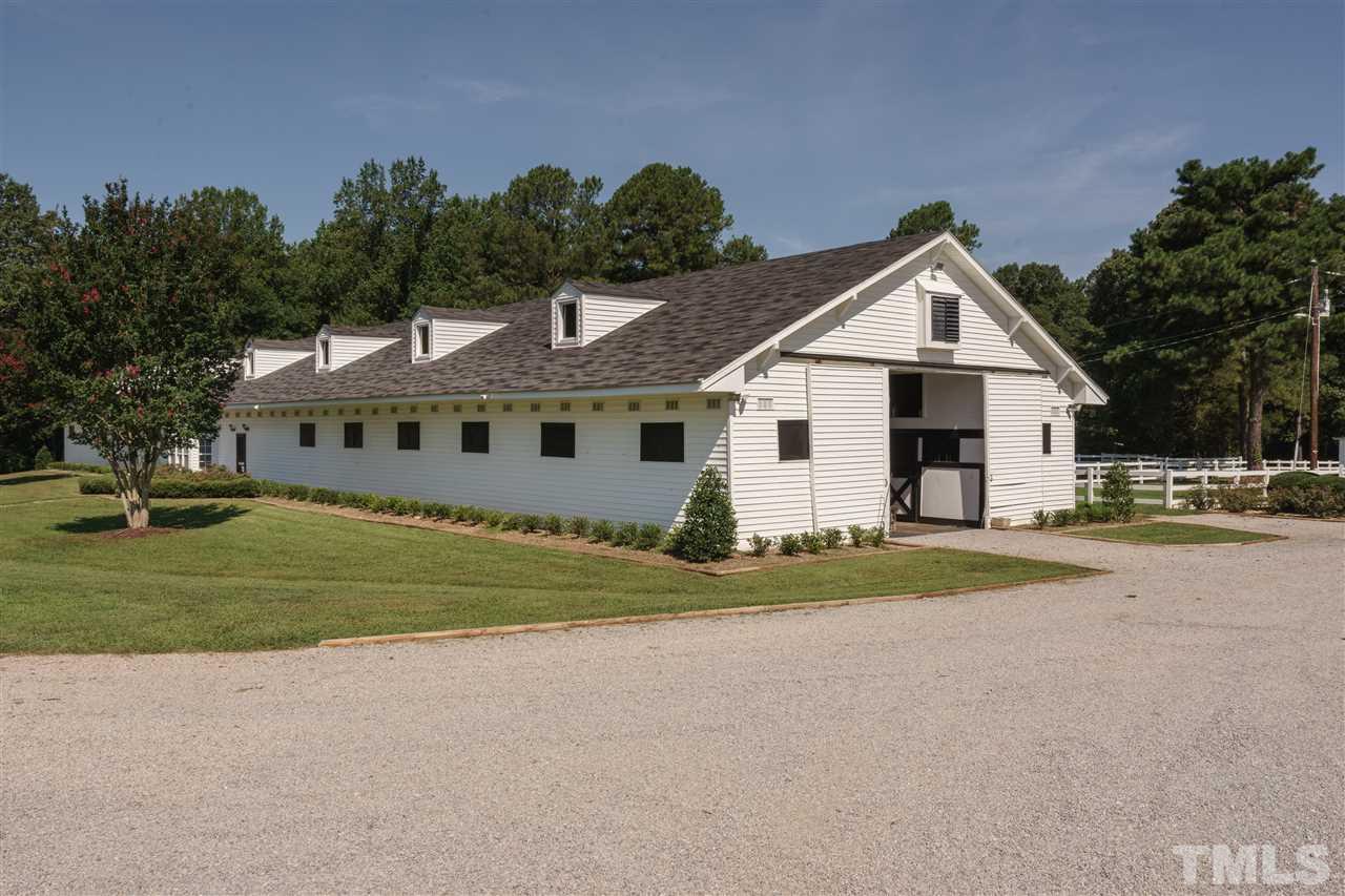 8446 Seven Paths Road Spring Hope, NC 27882 - Photo 16 of 24 a view of a white house with a big yard and potted plants