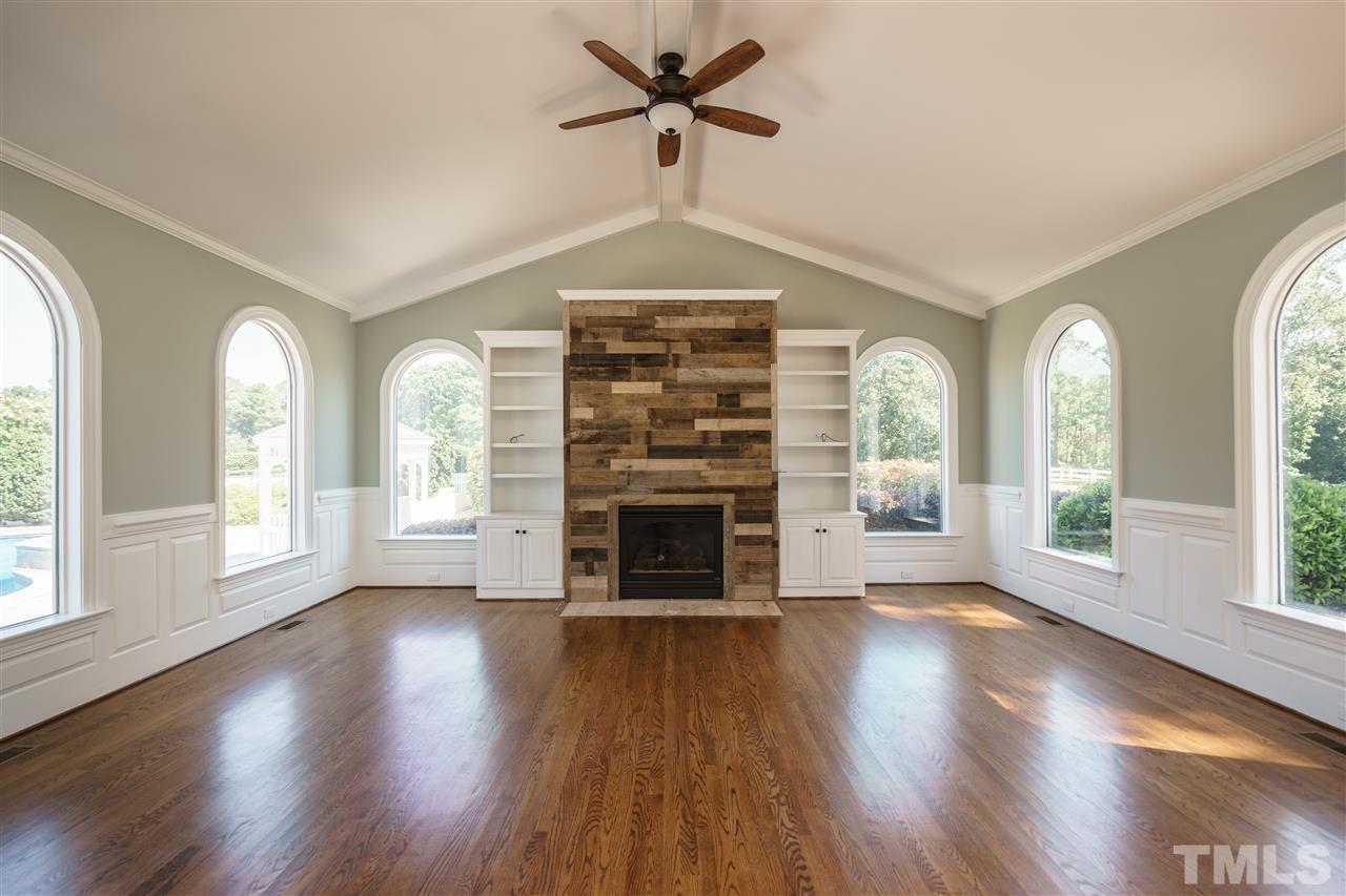 8446 Seven Paths Road Spring Hope, NC 27882 - Photo 5 of 24 a view of an empty room with wooden floor fireplace and a window